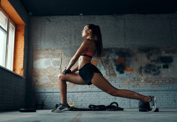 Beautiful,Young,Woman,Doing,Stretching,Exercises,In,Gym