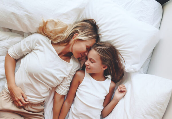 Mom,With,Her,Tween,Daughter,Relaxing,In,Bed,,Positive,Feelings,